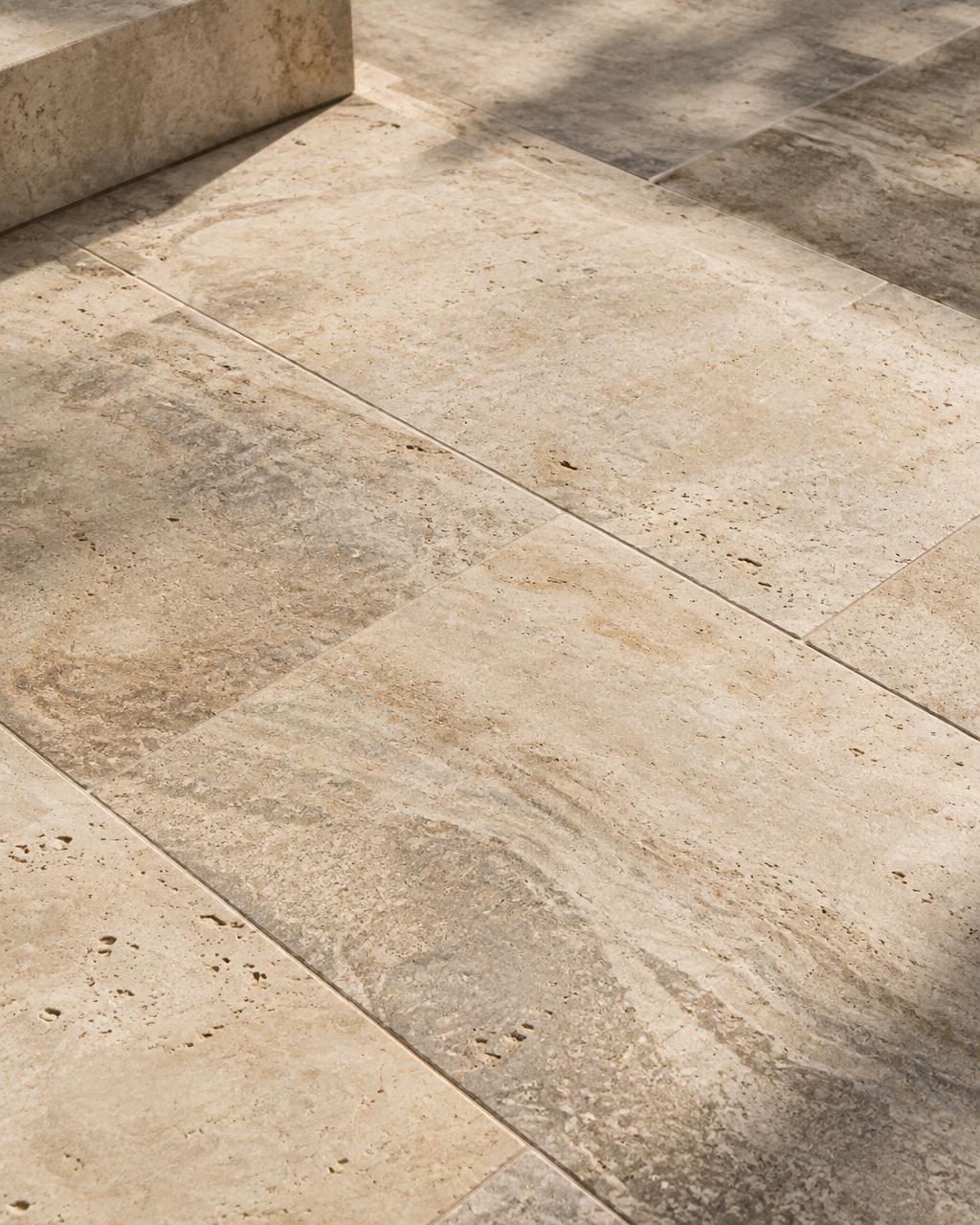 Honed travertine stone pavers laid outdoors in warm sunlight