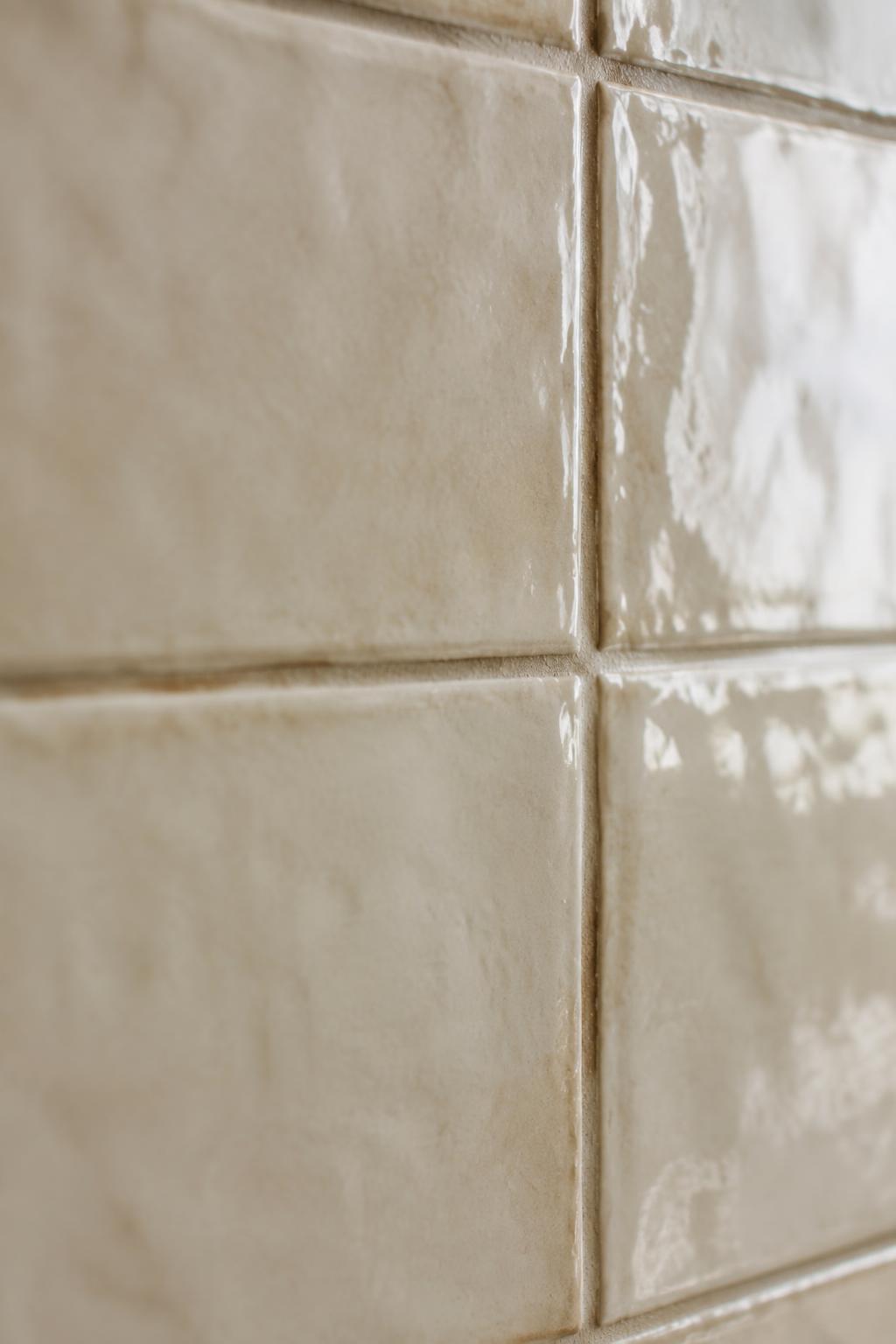 Close-up of hand-glazed warm ivory ceramic tiles